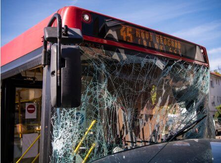 City bus with a heavily shattered windshield after a collision, illustrating bus accident cases handled by Aulsbrook Car & Truck Wreck Injury Lawyers Fort Worth