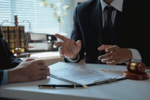 Attorney reviewing documents with a client beside a gavel at Aulsbrook Car & Truck Wreck Injury Lawyers Arlington